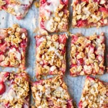 Strawberry Oatmeal Bars on a piece of white parchment paper