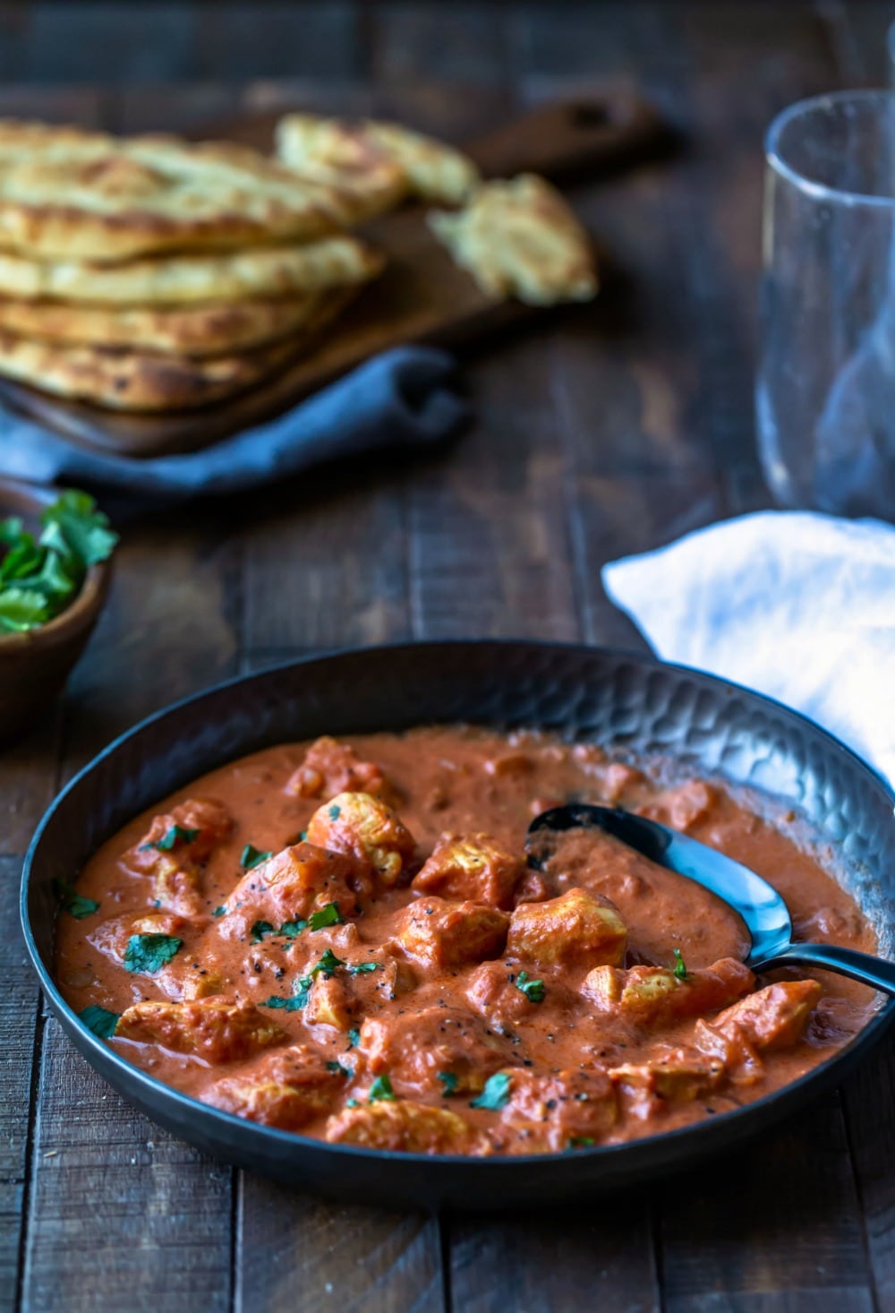 Easy chicken tikka masala in a metal dish with a black metal spoon