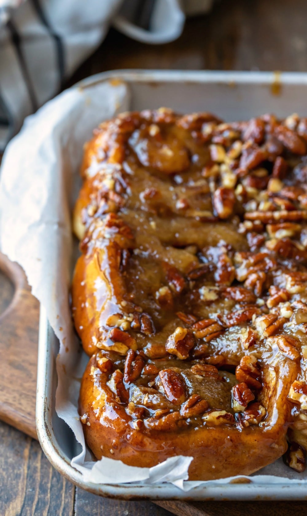 Easy sticky buns on a parchment paper-lined sheet pan
