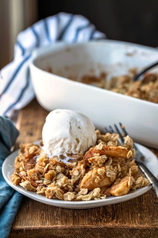 Apple crisp topped with a scoop of vanilla ice cream