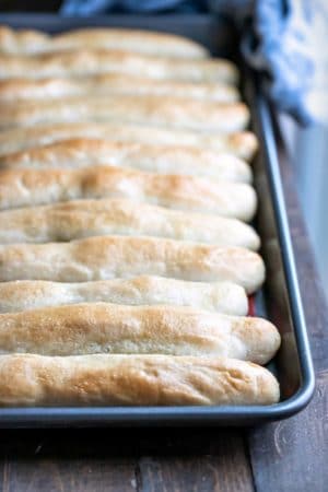 Pan of garlic breadsticks on a wooden surface