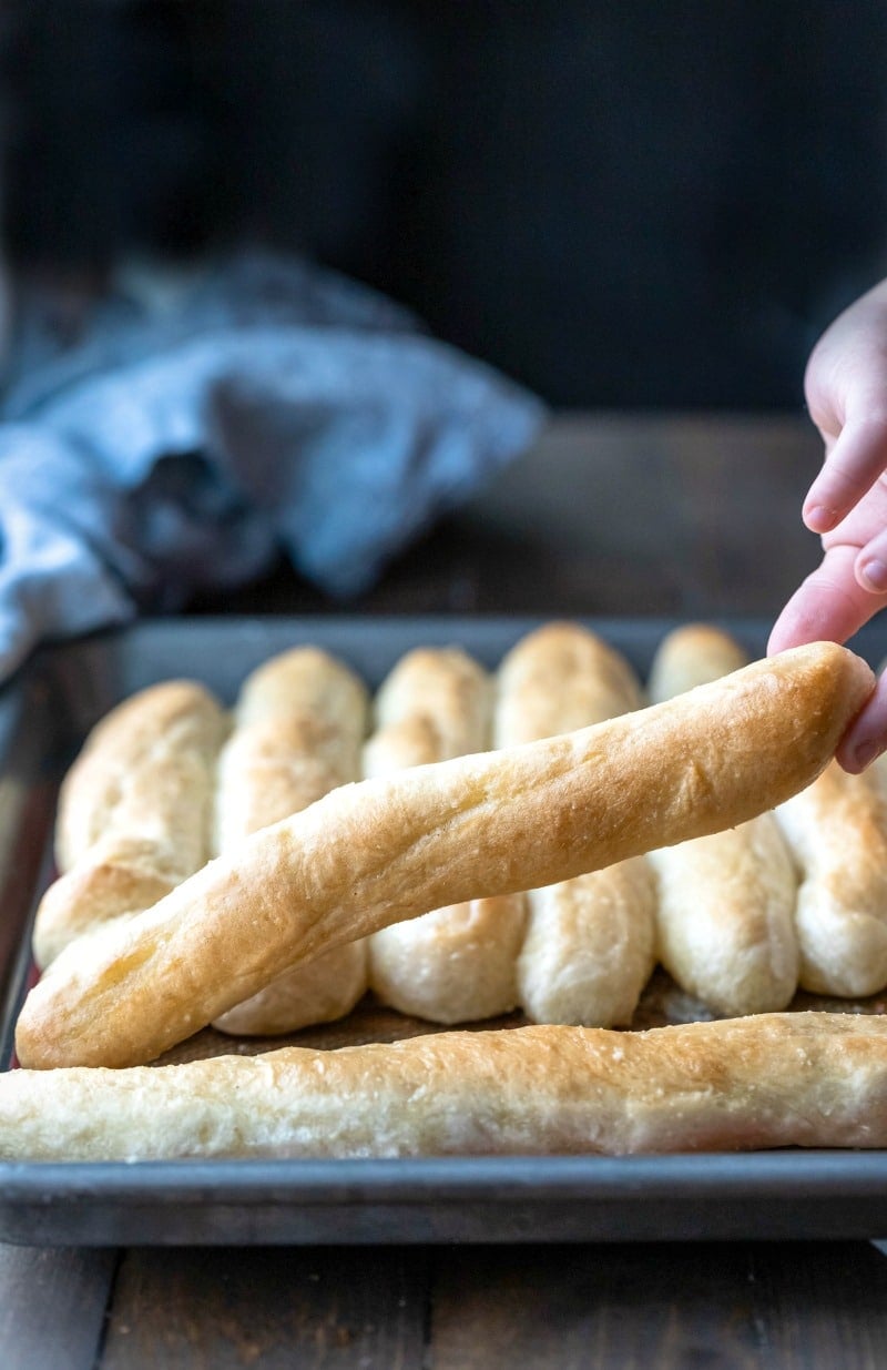 Hand picking up garlic breadstick