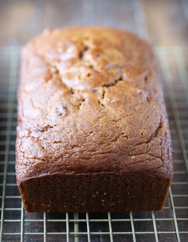 Loaf of pumpkin nut bread on a wire cooling rack