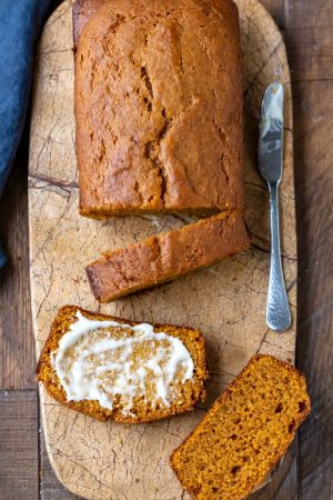 Sliced pumpkin bread on a marble cutting board