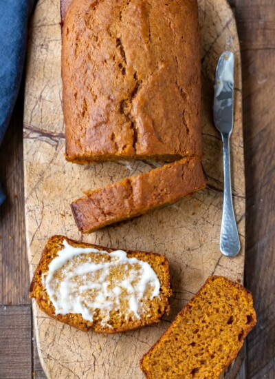 Sliced pumpkin bread on a marble cutting board