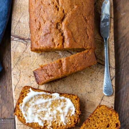 Sliced pumpkin bread on a marble cutting board