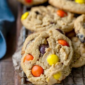 A stack of ultimate peanut butter cookies on a wire cooling rack.