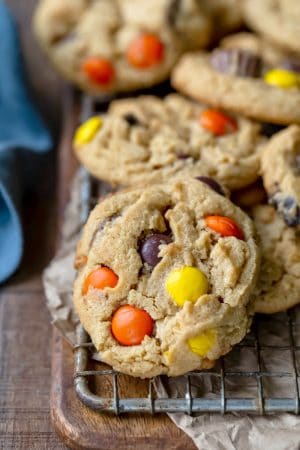 A stack of ultimate peanut butter cookies on a wire cooling rack.