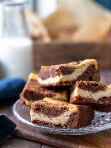 Stack of peanut butter brownies on a glass plate