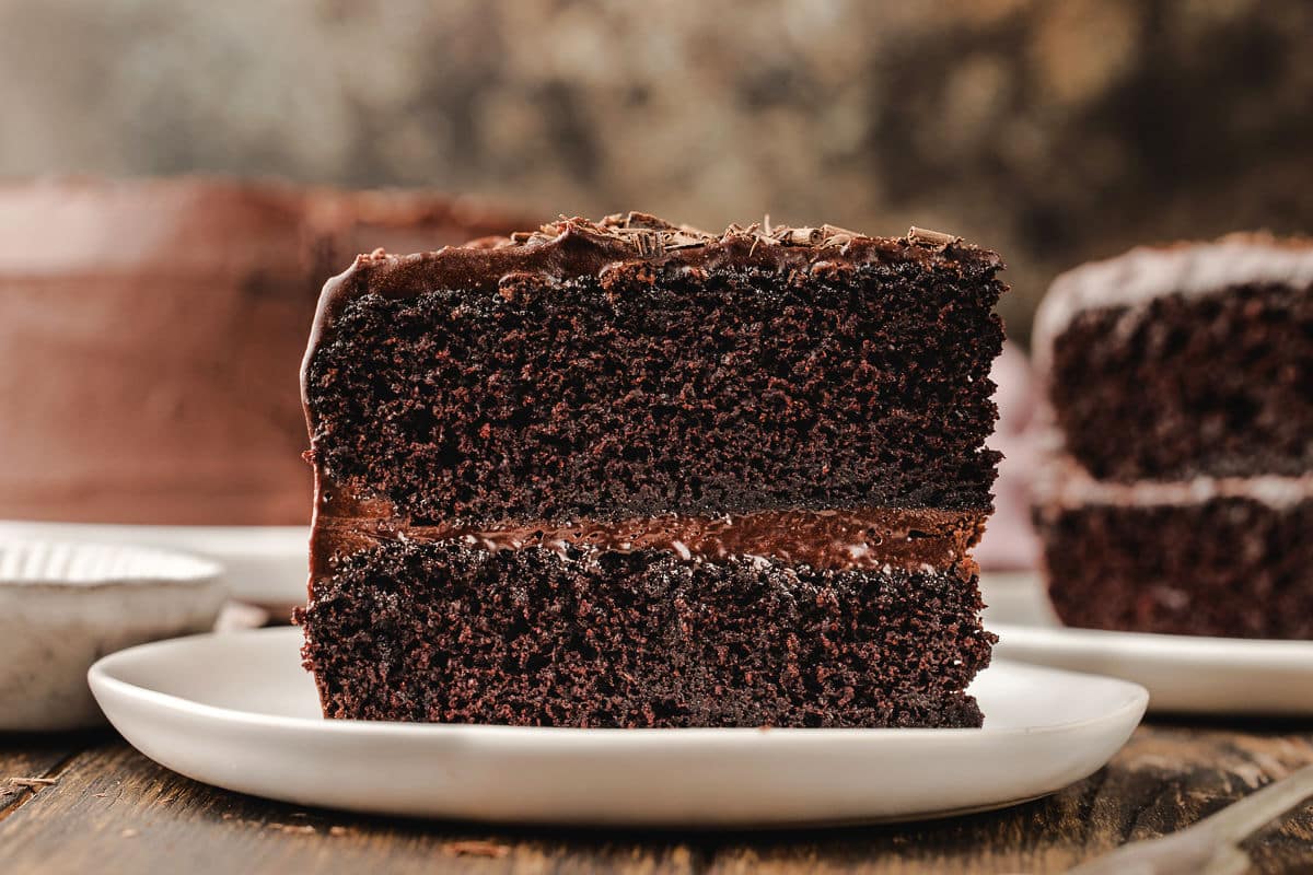 Slices of chocolate fudge cake on plates. 