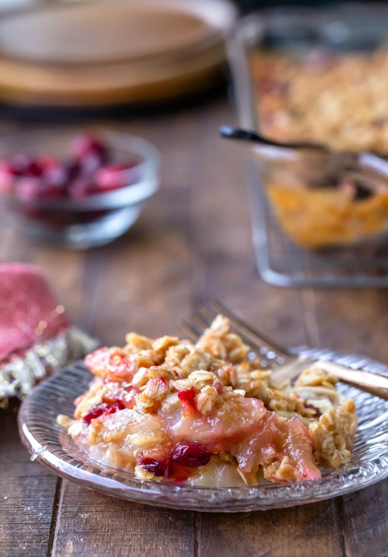 Cranberry apple crisp on a glass plate with a gold fork