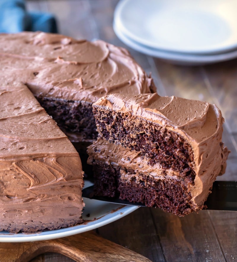 Knife removing a slice of chocolate fudge cake