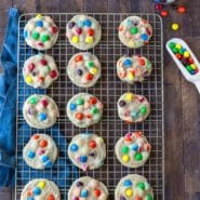 M&M Cookies on a gold wire cooling rack