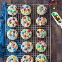 M&M Cookies on a gold wire cooling rack