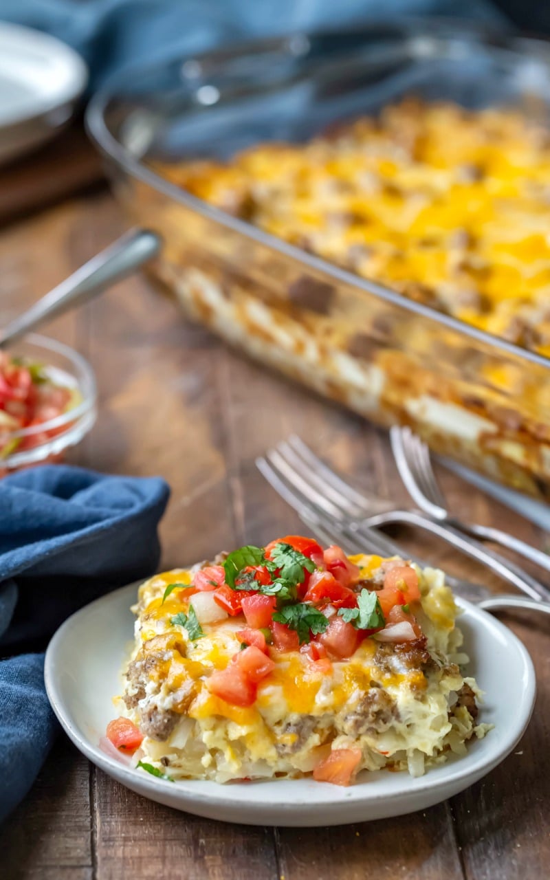 Piece of sausage breakfast casserole topped with pico de gallo and cilantro