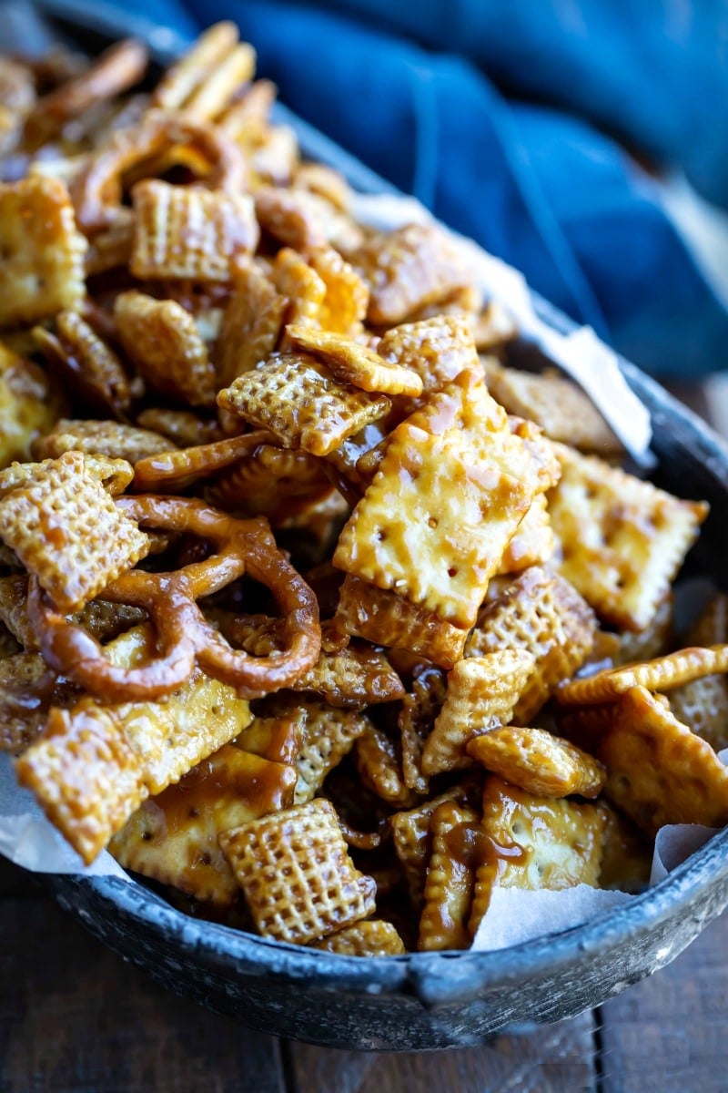 Toffee chex mix in a parchment-lined metal dish