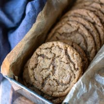 Molasses cookies in a silver metal tin