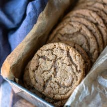Molasses cookies in a silver metal tin