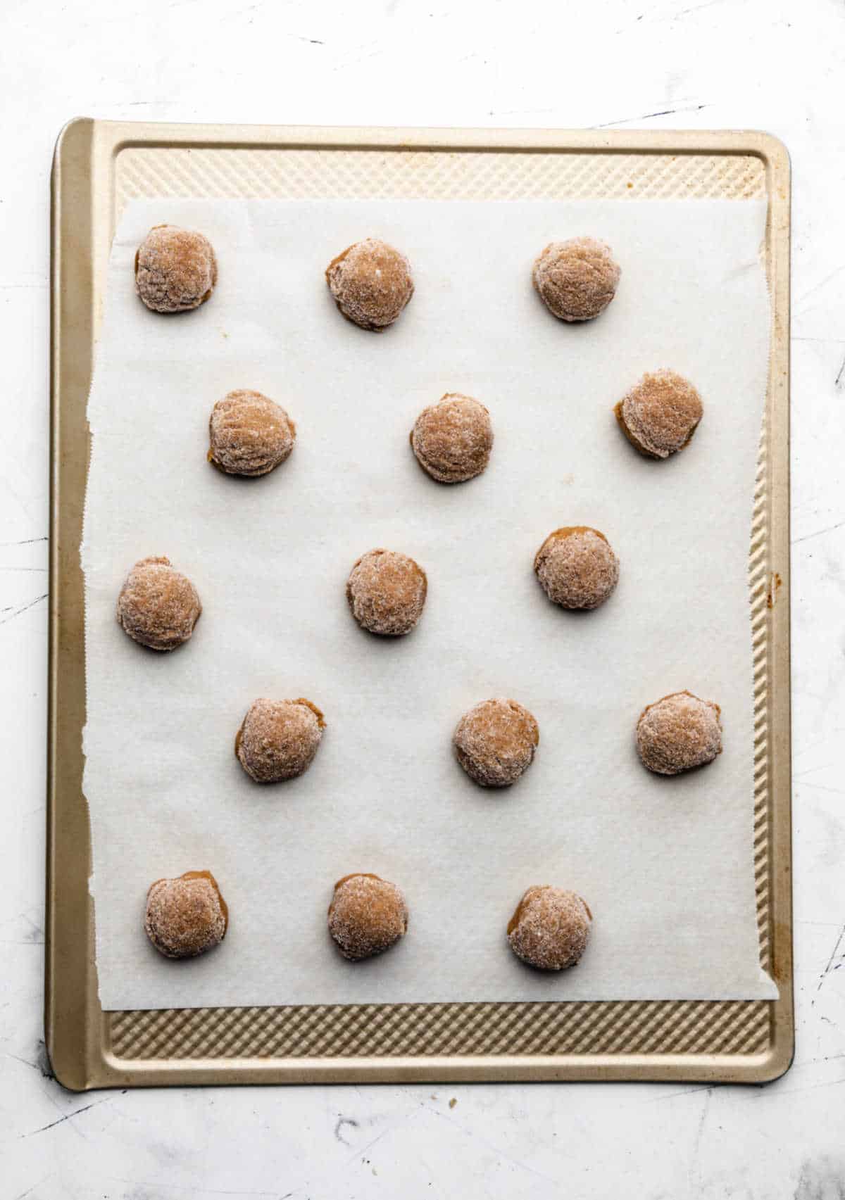 Molasses cookie dough on a baking sheet. 