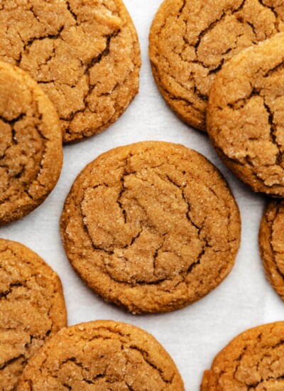 Molasses cookies on a sheet of white parchment paper.