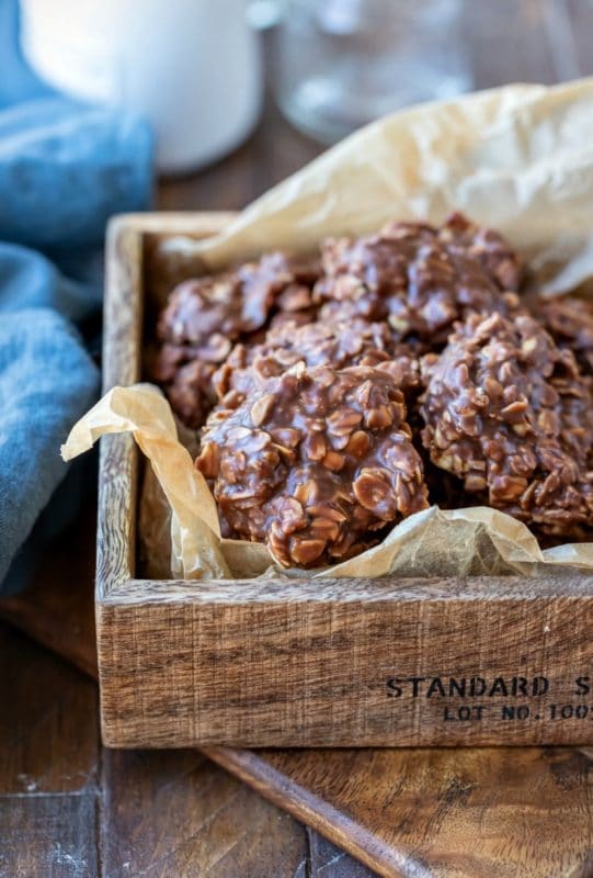 Chocolate no bake cookies in a wooden box lined with brown parchment