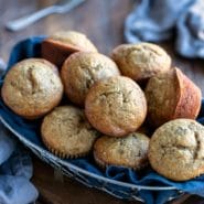 Banana bread muffins in a blue linen lined basket