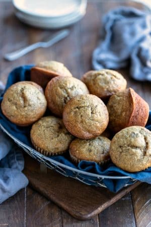 Banana bread muffins in a blue linen lined basket