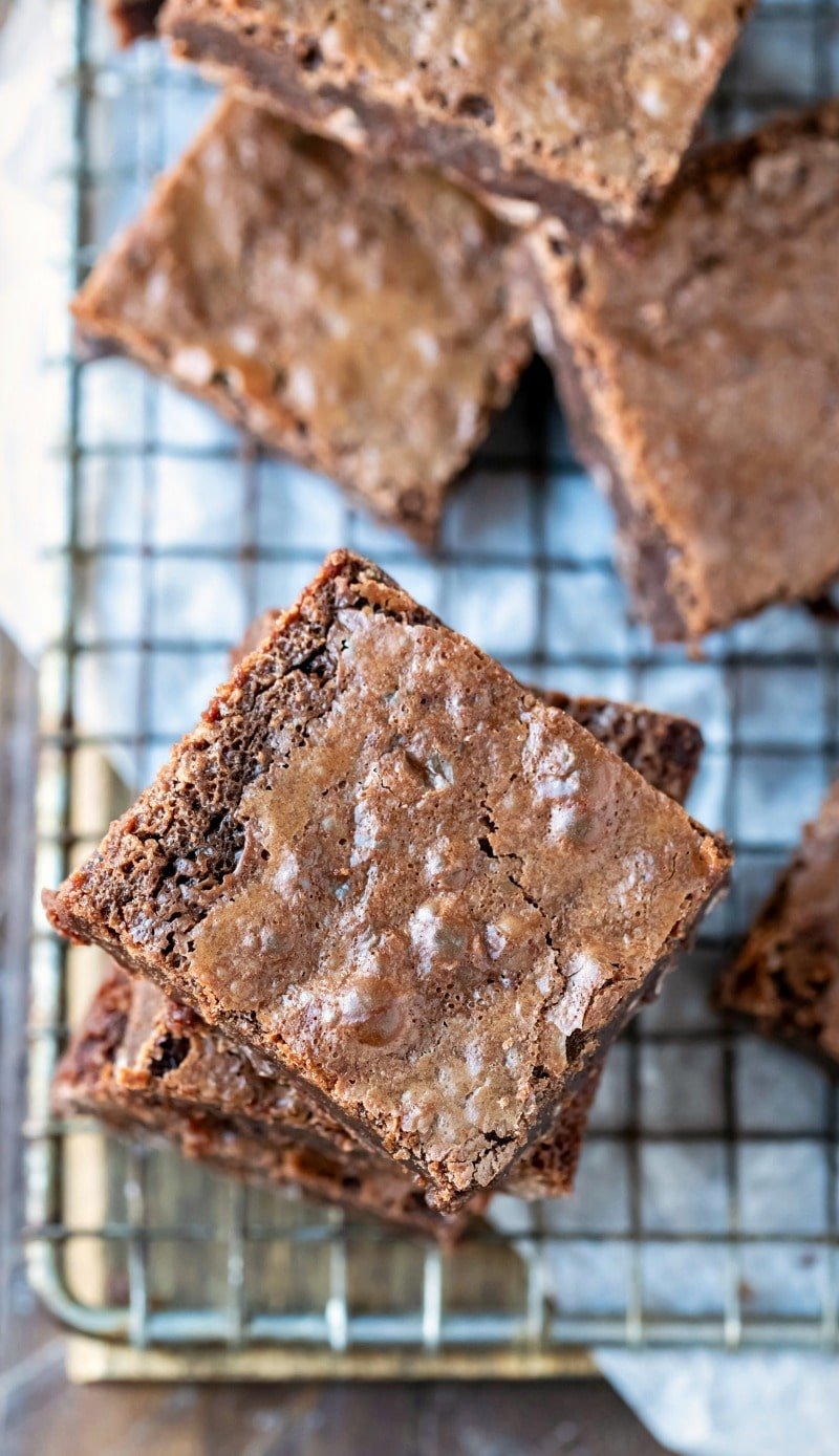 Stack of flourless brownies on a wire cooling rack