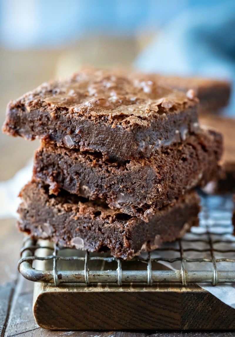 3 flourless brownies stacked on a wire cooling rack