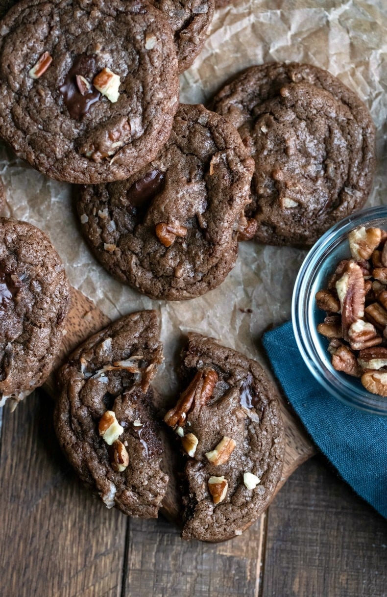 German chocolate cookie broken in half on a piece of brown parchment paper