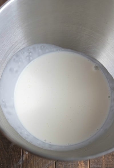 Heavy whipping cream in a silver mixing bowl