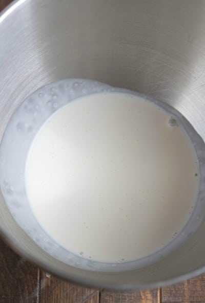 heavy whipping cream in a silver mixing bowl