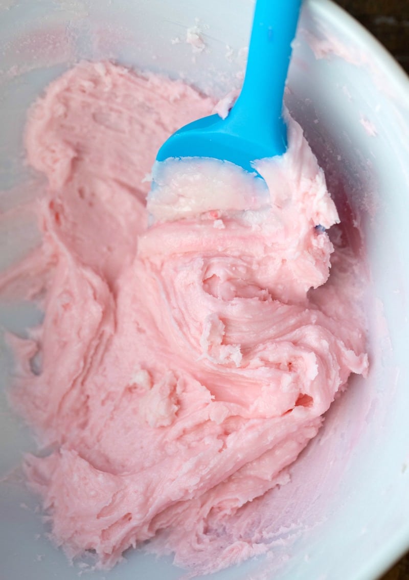 Pink frosting in a mixing bowl