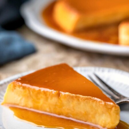 Slice of flan de queso topped with caramel sauce