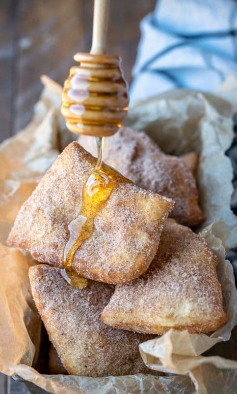 Honey dripping onto pile of sopaipillas