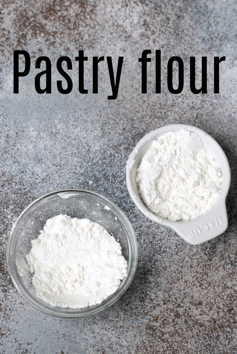Pastry flour in a glass dish and in a ceramic measuring cup