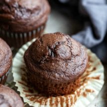 Chocolate chocolate chip muffin with the muffin liner pulled down