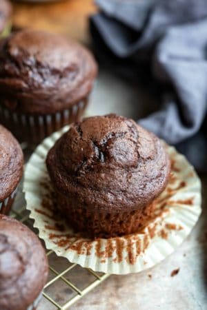 Chocolate chocolate chip muffin with the muffin liner pulled down