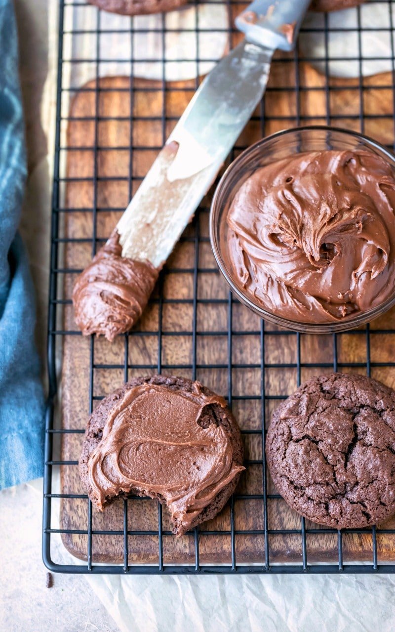 Chocolate frosted cookie next to an unfrosted chocolate cookie