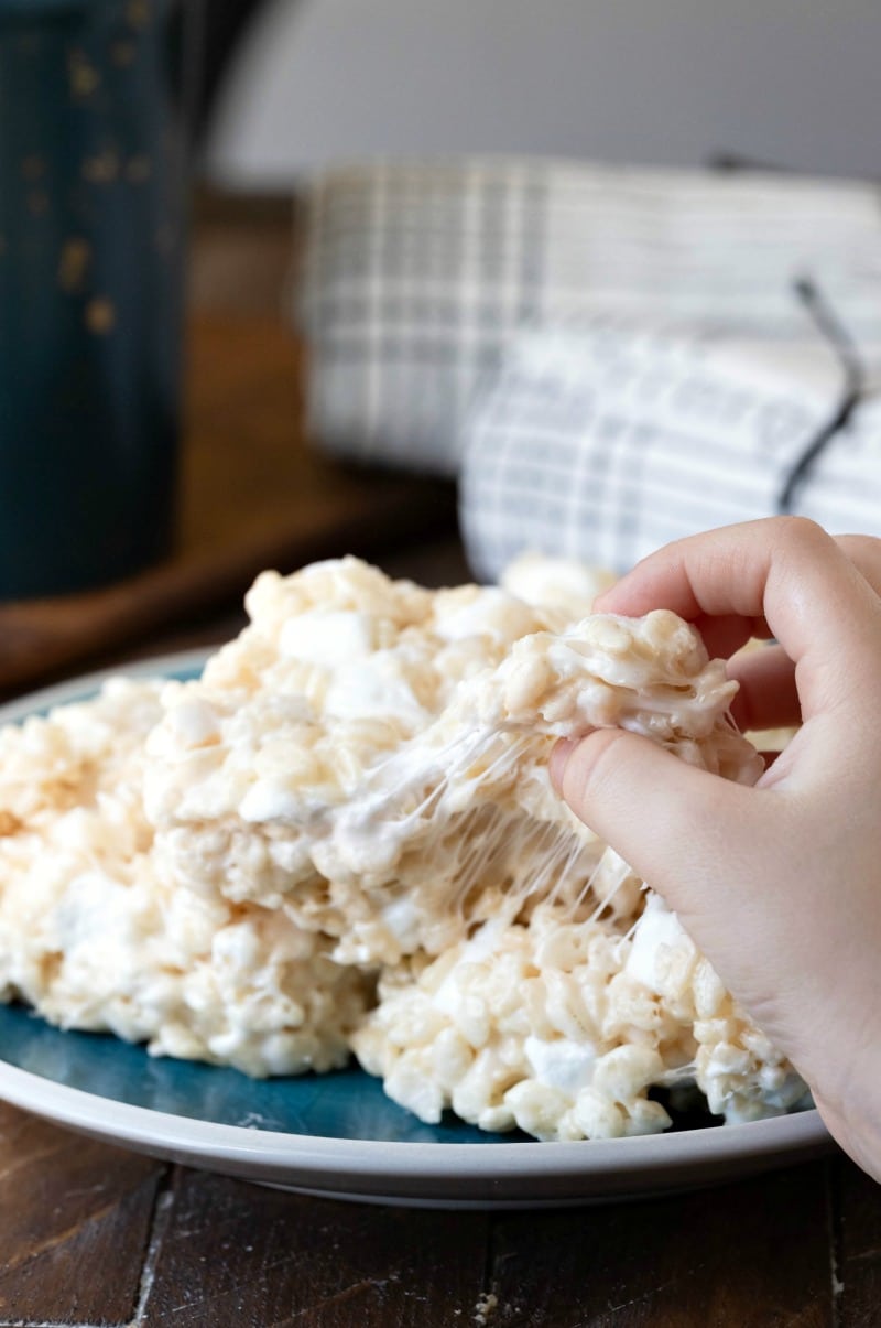 Hand pulling a piece off of a rice krispies treat