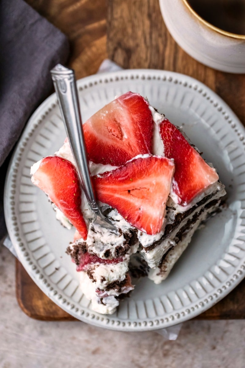 Slice of strawberry icebox cake on a cream plate