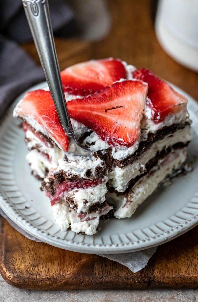 Fork taking a bite of strawberry icebox cake