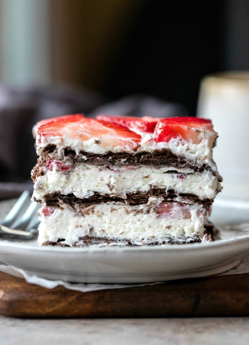 Slice of strawberry icebox cake next to a silver fork