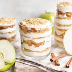 Apple pie parfait on a wooden cutting board.