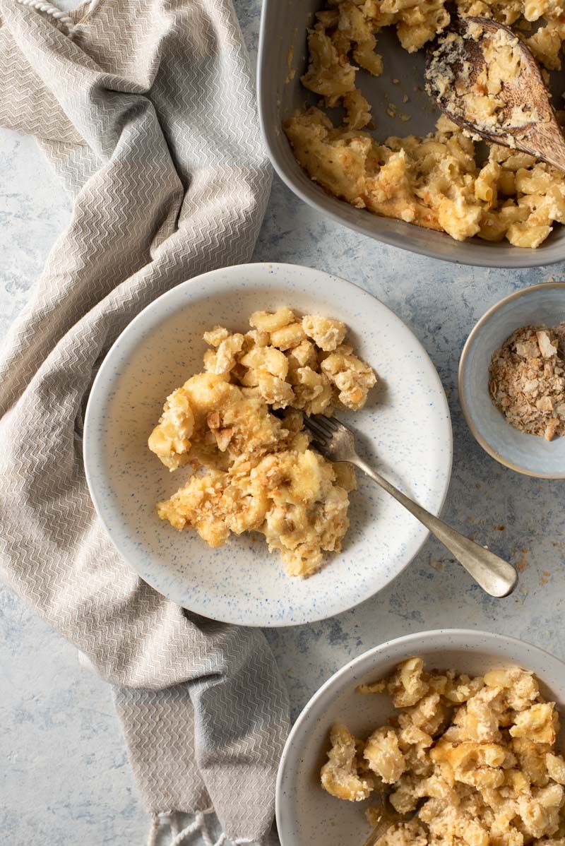 Cauliflower mac and cheese in two bowls with a fork