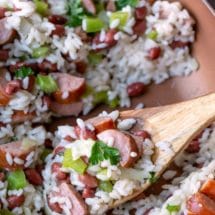 Red beans and rice in a skillet wiht a wooden spoon in it