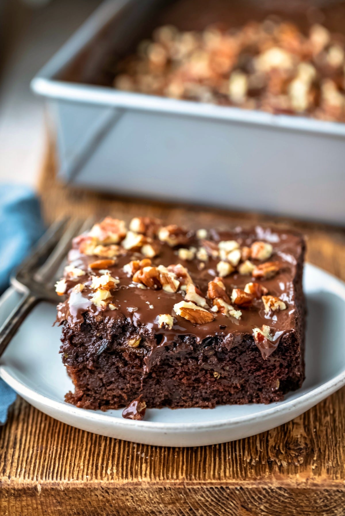 Chocolate Zucchini Cake Slice of chocolate zucchini cake on a cream plate
