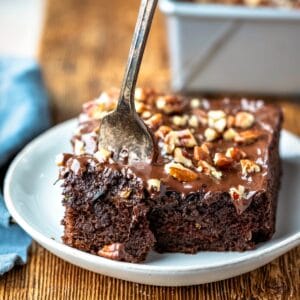 Silver fork taking a bite of chocolate zucchini cake