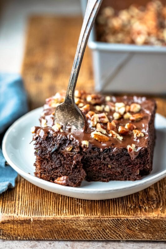 Silver fork taking a bite of chocolate zucchini cake