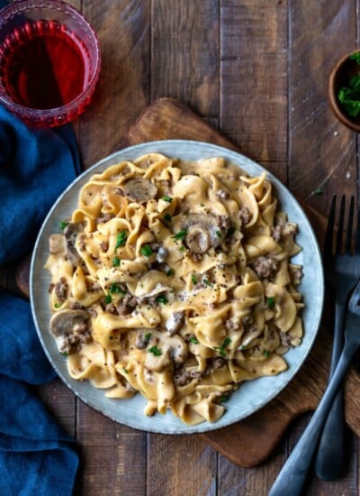 Blue plate with Instant Pot Beef Stroganoff next to two black forks